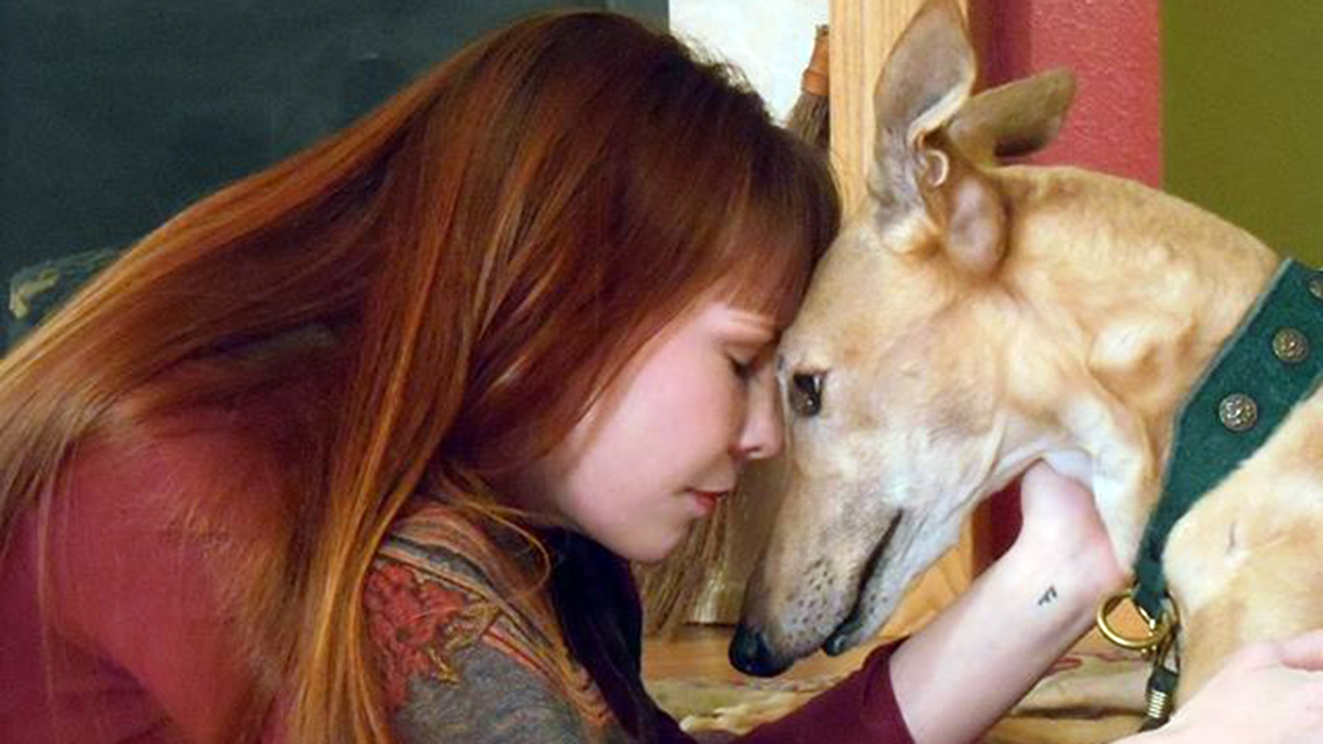 leo_theresa_header Woman sharing a loving moment with her dog, showing the bond and compassion offered by Peace for Paws in Las Vegas